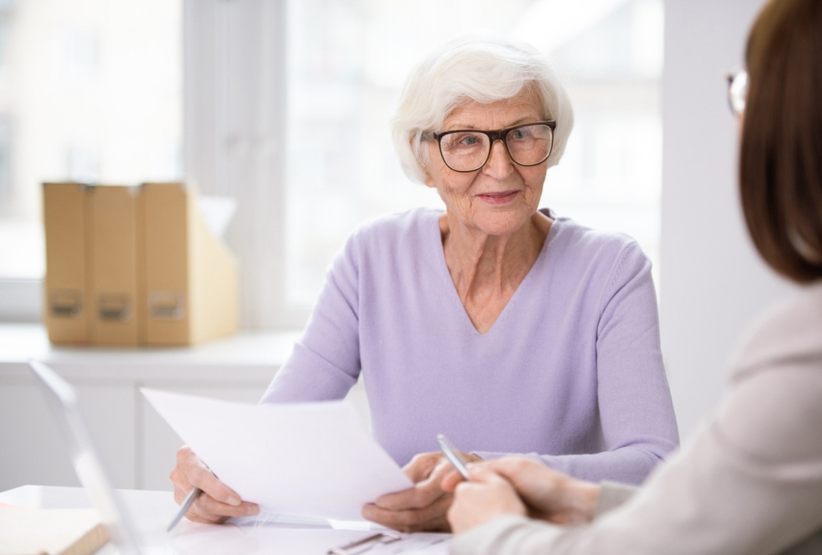 An image shows an older woman discussing the new CSA amendments designed to provide better protection for vulnerable investors