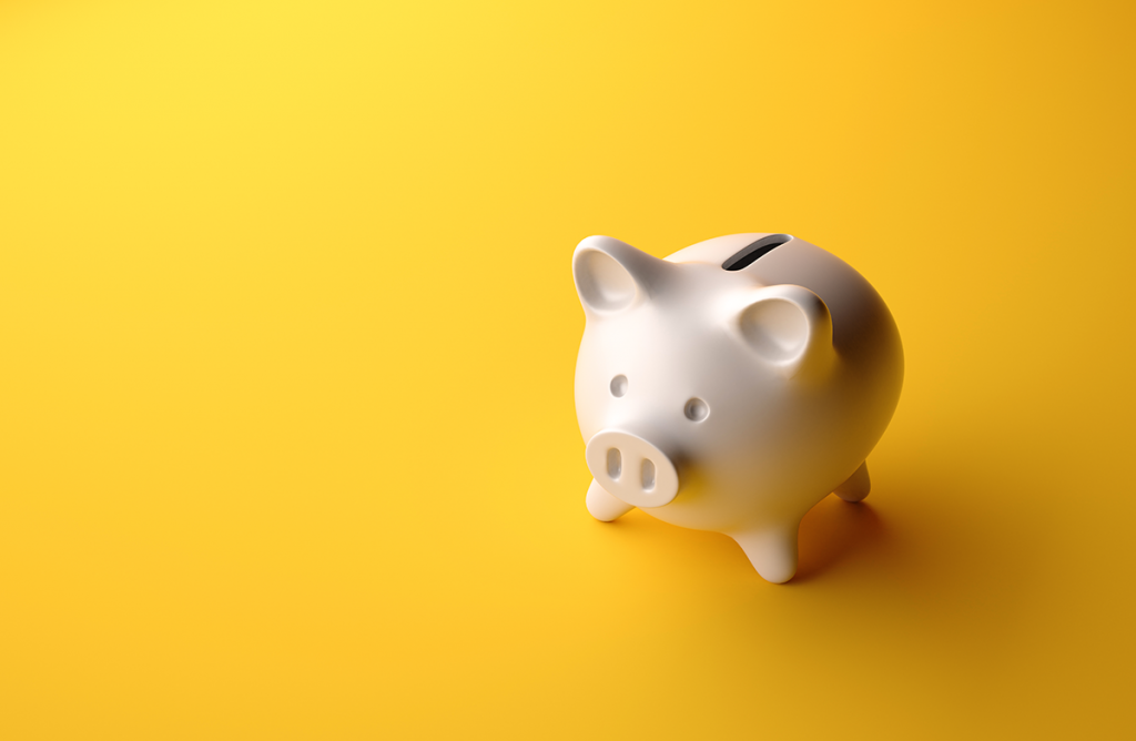 this image of a ceramic piggy bank on a yellow background represents the importance of saving or investing for retirement as soon as you can.