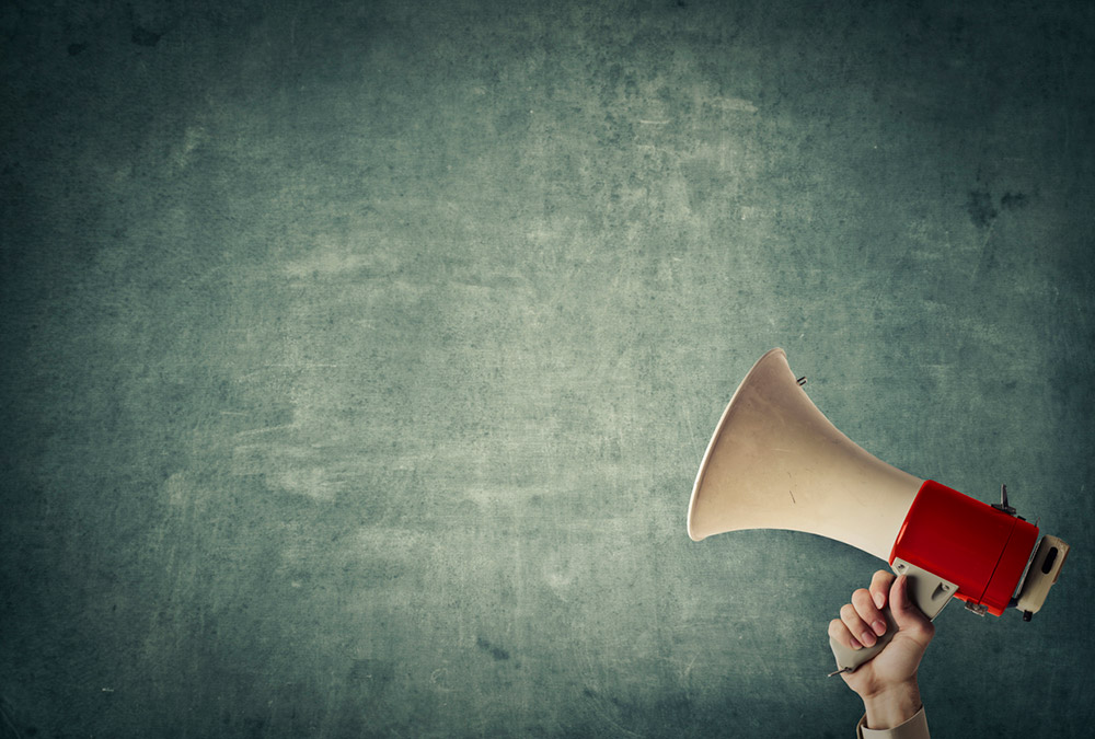 This image of a person holding a megaphone represents the BCSC warning British Columbia investors about unregistered activity or unqualified securities being promoted in the province.