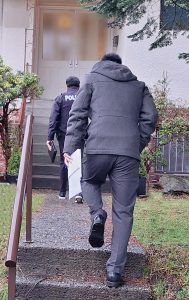 A BCSC investigator and an RCMP officer pay a visit to a suspected money mule.